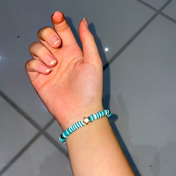 A beautiful blue and white bracelet with gold star and circle beads. Stretchy. - Picture 1 of 3